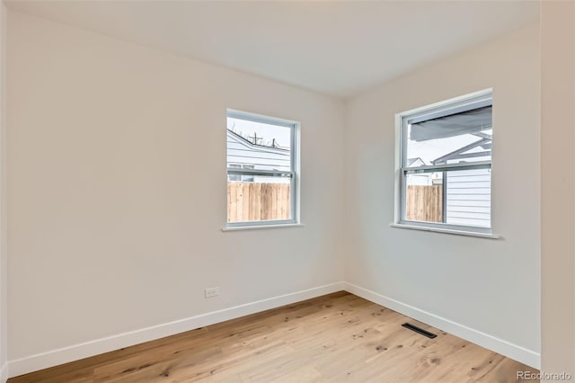 1120 Xenia St, Denver, CO 80220 - unfurnished room featuring visible vents, light wood-style flooring, and baseboards
