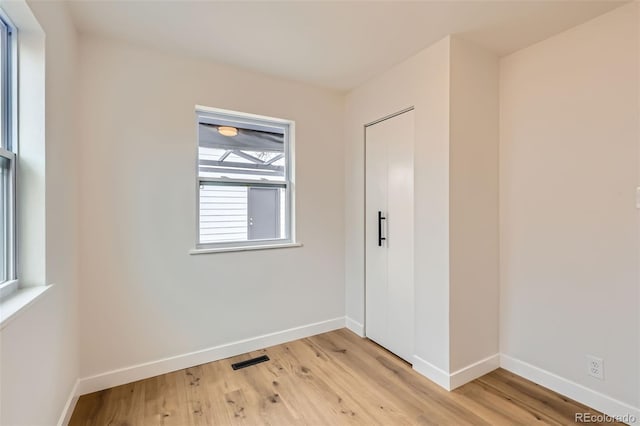 1120 Xenia St, Denver, CO 80220 - spare room with visible vents, light wood-style floors, and baseboards