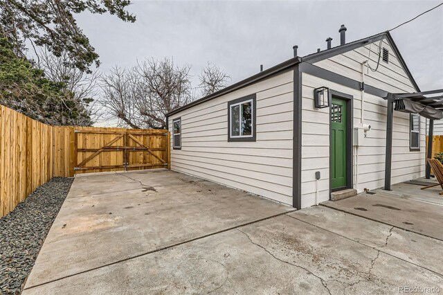 1120 Xenia St, Denver, CO 80220 - view of side of home with a patio, a gate, and fence