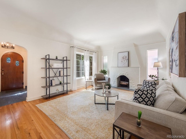 1470 Utica St, Denver, CO 80204 - living area with arched walkways, hardwood / wood-style flooring, and a brick fireplace