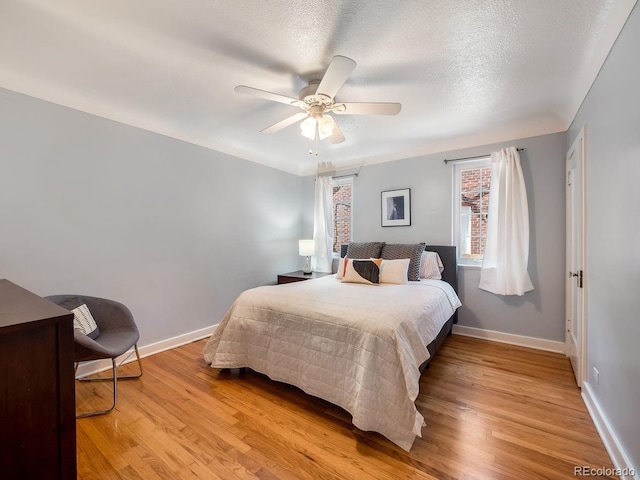 1470 Utica St, Denver, CO 80204 - bedroom featuring light wood-type flooring, a ceiling fan, and a textured ceiling