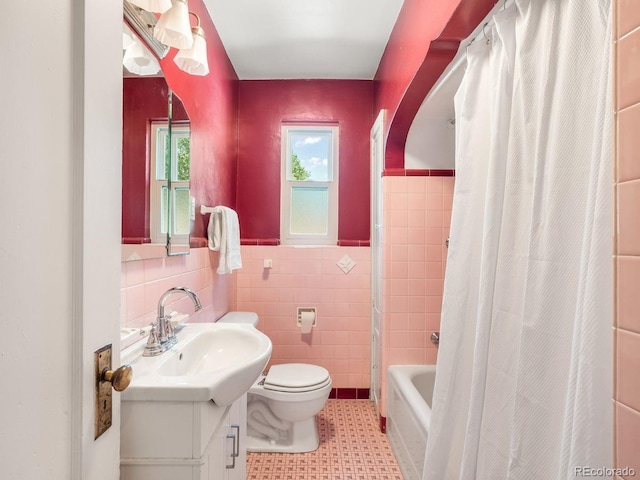 1470 Utica St, Denver, CO 80204 - bathroom with vanity, tile walls, shower / tub combo, a wainscoted wall, and tile patterned flooring