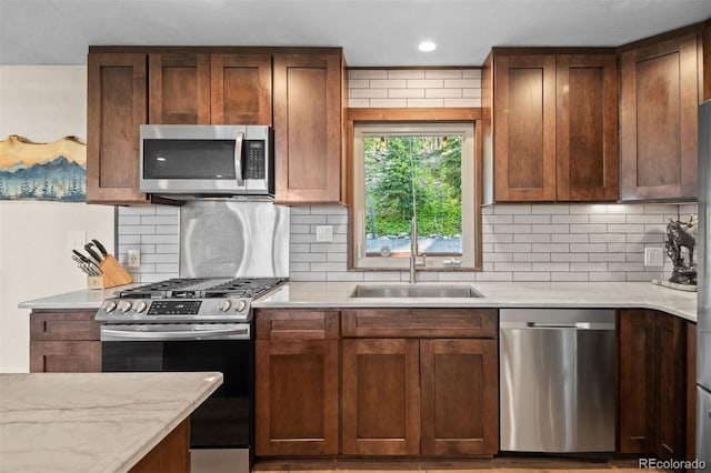 375 Castlewood Dr, Evergreen, CO 80439 - kitchen with appliances with stainless steel finishes, tasteful backsplash, and light stone counters
