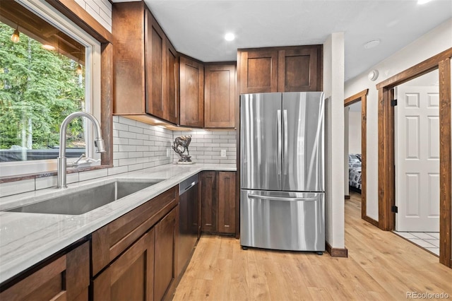 375 Castlewood Dr, Evergreen, CO 80439 - kitchen with stainless steel appliances, light stone counters, tasteful backsplash, light wood-type flooring, and recessed lighting