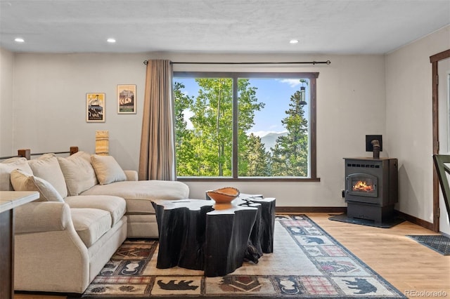 375 Castlewood Dr, Evergreen, CO 80439 - living area featuring wood finished floors, recessed lighting, and a wood stove