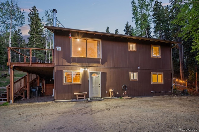 375 Castlewood Dr, Evergreen, CO 80439 - back of house at dusk with stairs and a deck