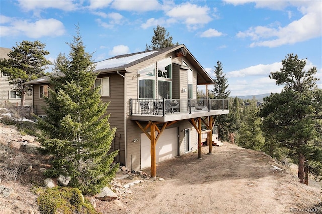 exterior space with a garage and a wooden deck