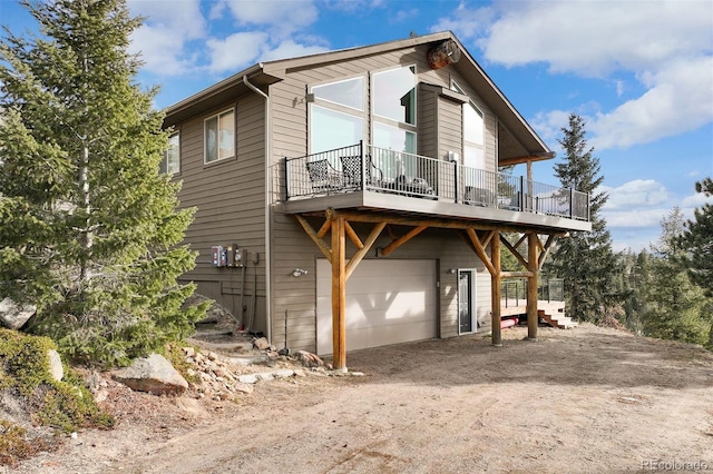 exterior space with a wooden deck and a garage