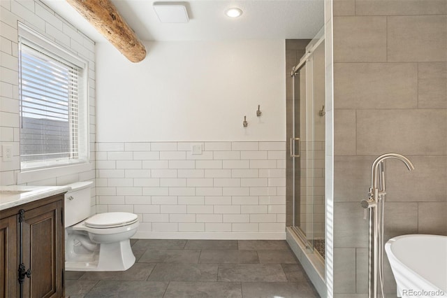 full bathroom featuring separate shower and tub, vanity, tile walls, and toilet