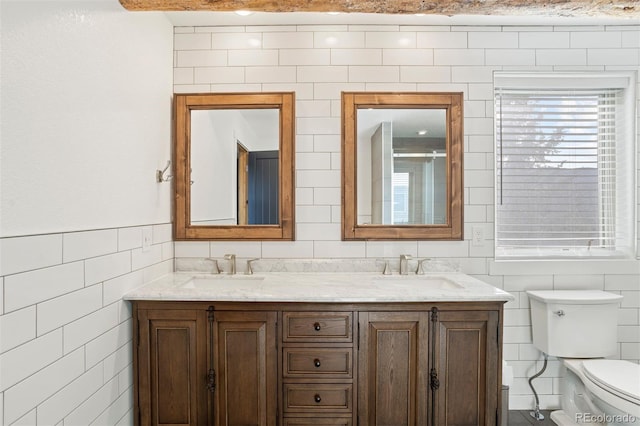 bathroom featuring a shower, vanity, tile walls, and toilet