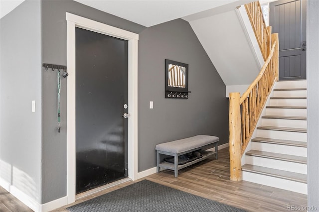 foyer entrance featuring hardwood / wood-style flooring and lofted ceiling