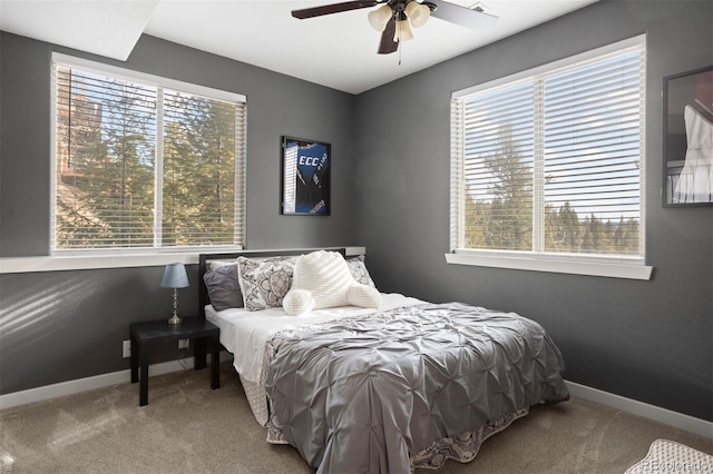 bedroom featuring carpet flooring, multiple windows, and ceiling fan