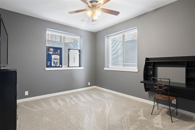 office space featuring ceiling fan, plenty of natural light, and light colored carpet