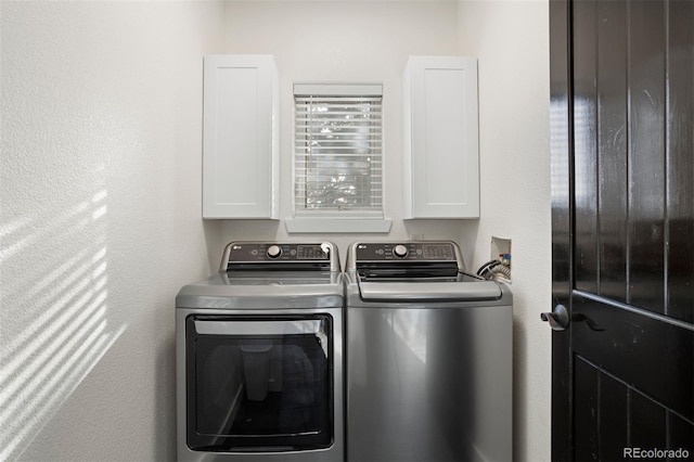 laundry area featuring cabinets and washing machine and clothes dryer