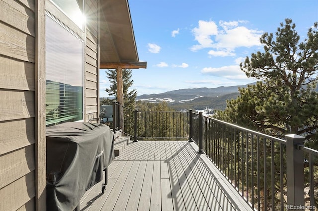 wooden deck featuring a grill and a mountain view