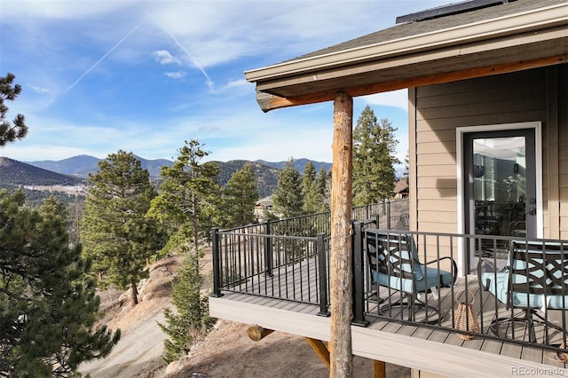 wooden deck featuring a mountain view