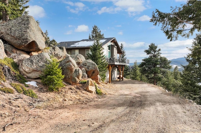 view of property exterior with a deck with mountain view