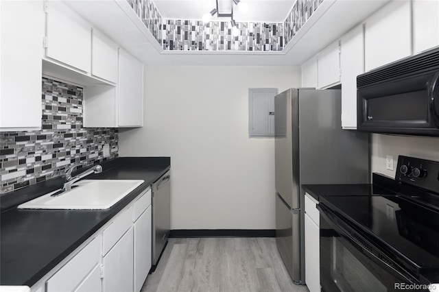 kitchen with decorative backsplash, white cabinets, black appliances, light hardwood / wood-style flooring, and sink