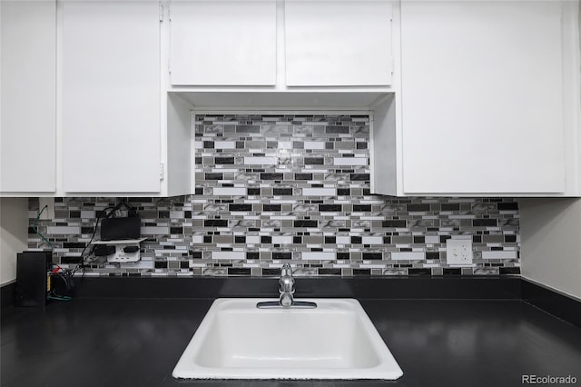 kitchen with sink, white cabinets, and tasteful backsplash