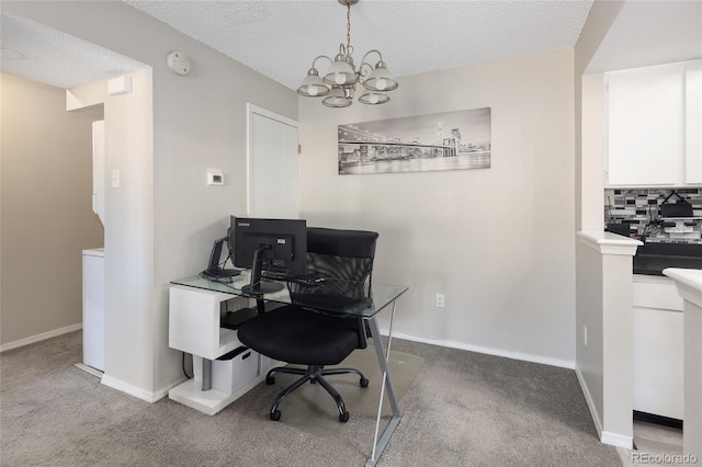 home office with a textured ceiling, light colored carpet, and a notable chandelier