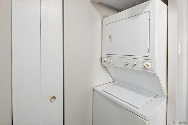 laundry room with stacked washer and dryer