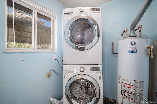 laundry area featuring laundry area, stacked washer / dryer, and gas water heater