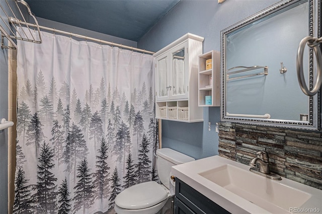 bathroom with vanity, toilet, and curtained shower