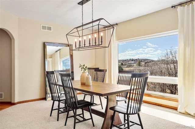 carpeted dining area featuring a healthy amount of sunlight