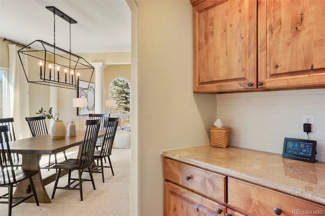 dining area featuring decorative columns