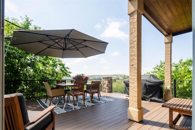 wooden terrace featuring a grill