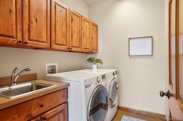 laundry room featuring cabinets, washer and clothes dryer, and sink