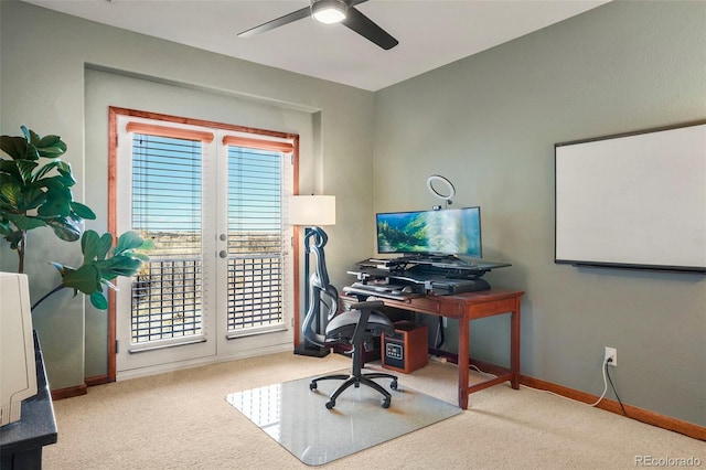 carpeted office space with french doors and ceiling fan