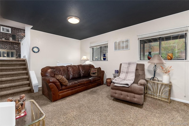 living area with carpet floors, baseboards, visible vents, and stairway