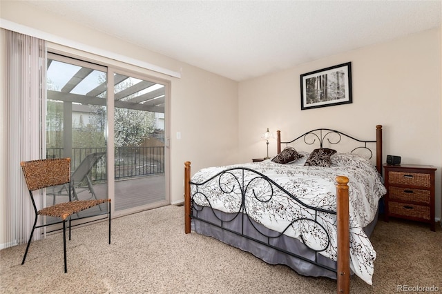 bedroom with access to outside and carpet flooring