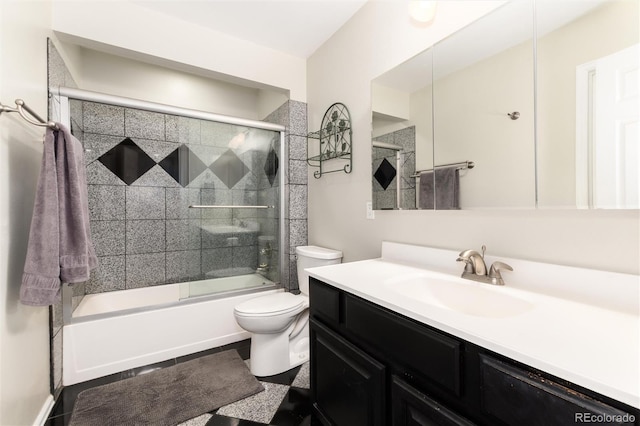 bathroom featuring vanity, bath / shower combo with glass door, and toilet