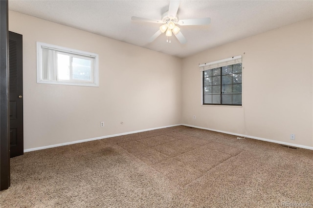 unfurnished room featuring carpet floors, baseboards, and ceiling fan