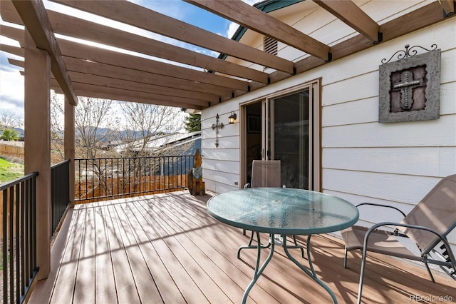 deck with a pergola, a mountain view, and outdoor dining space