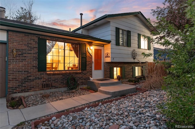 split level home with brick siding
