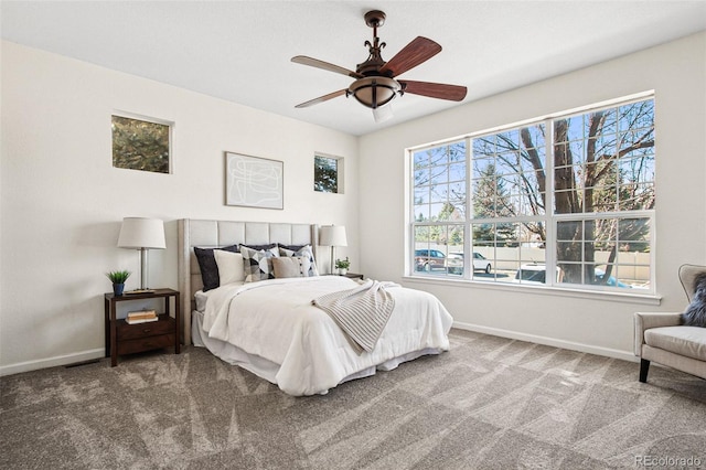 carpeted bedroom featuring ceiling fan and baseboards