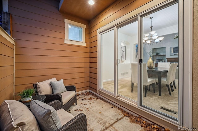 exterior space with visible vents and an inviting chandelier