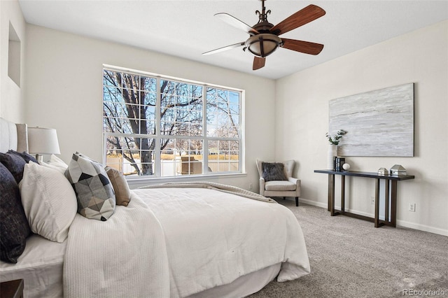 bedroom with ceiling fan, baseboards, and carpet flooring