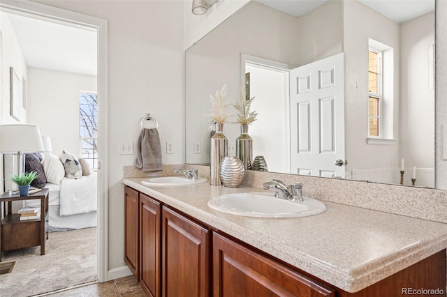 bathroom with a sink, ensuite bath, and double vanity