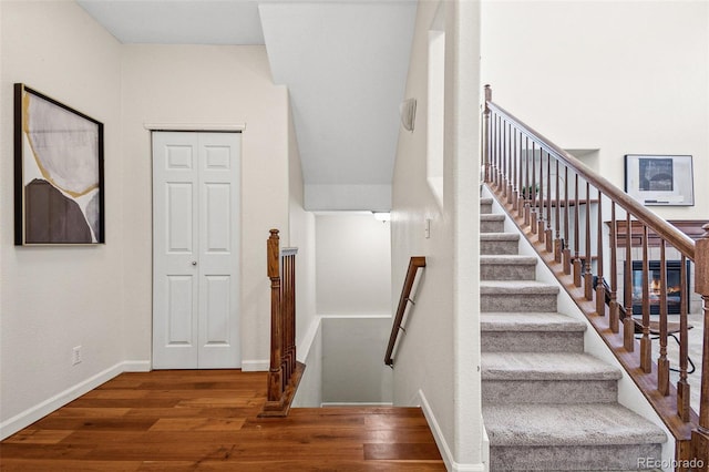 stairs with baseboards and wood finished floors