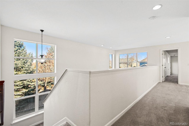 hall with carpet floors, recessed lighting, an upstairs landing, and baseboards