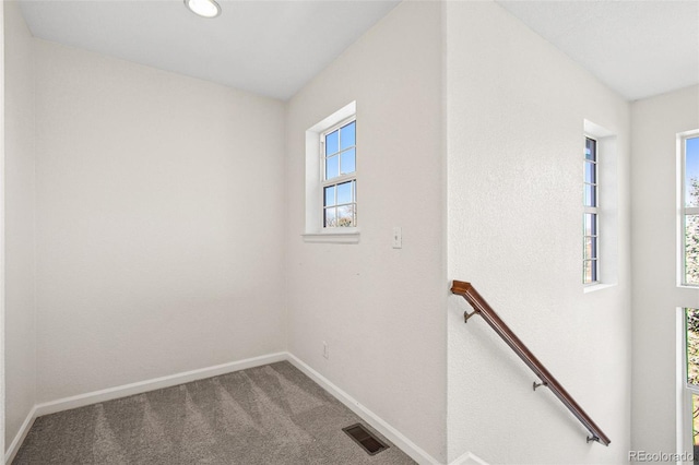 interior space with carpet, visible vents, and baseboards