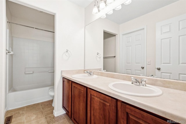 full bath with toilet, double vanity, visible vents, and a sink