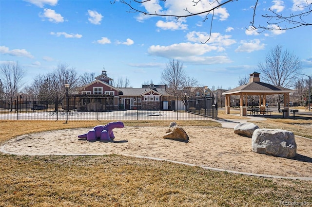 communal playground featuring a gazebo and fence