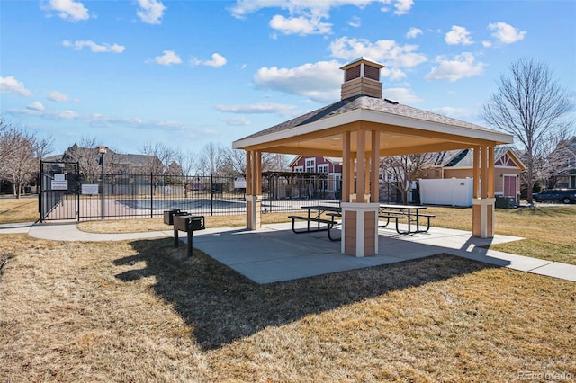 surrounding community featuring fence, a patio, a gazebo, and a lawn