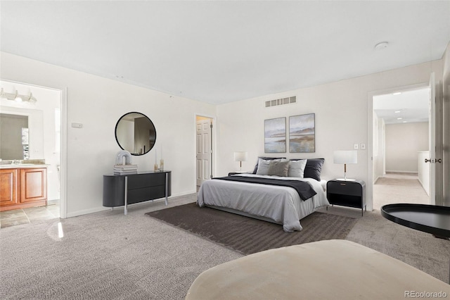12997 Wyandot Way, Westminster, CO 80234 - bedroom featuring light colored carpet, ensuite bathroom, and baseboards