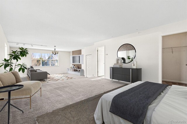 12997 Wyandot Way, Westminster, CO 80234 - bedroom featuring carpet flooring, a spacious closet, baseboards, and a closet